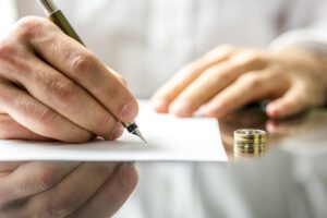 Man signing divorce documents.
